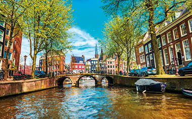 A view down a canal in Amsterdam, Netherlands A view down a canal in Amsterdam, Netherlands